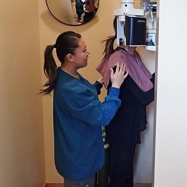 A member of our dental team assisting a patient with a dental x-ray to show that this dentist in Seattle uses the latest technology